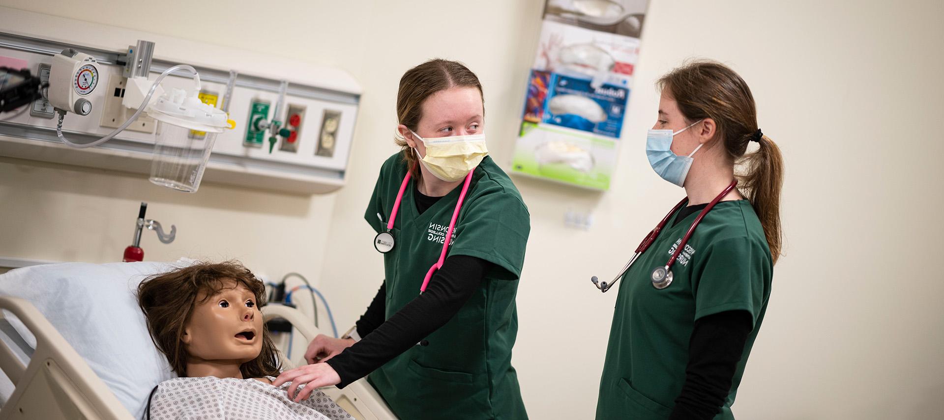 Nursing students in lab with simulator